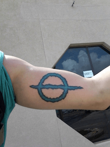The Symbol of Phyrexia tattoo