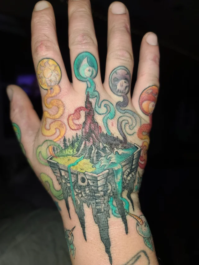 MTG mana symbols pooling into naturescape tattoo